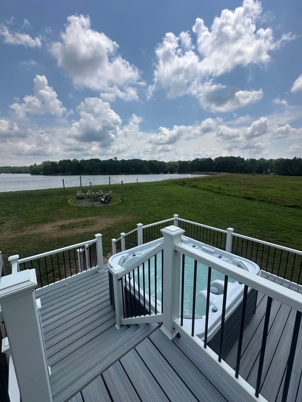 Overhead view of the hot tub deck, fire pit seating circle and lake