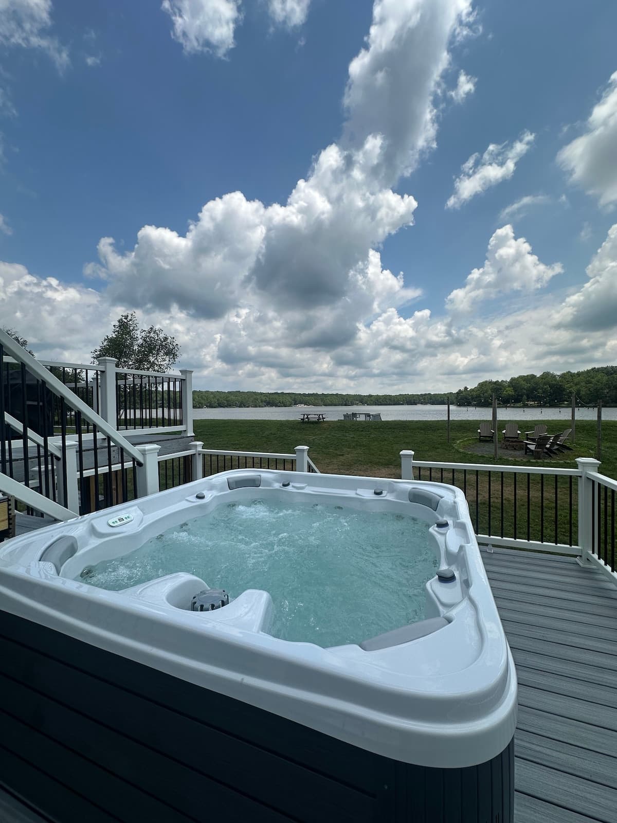 Hot tub on a composite deck overlooking the lawn and lake